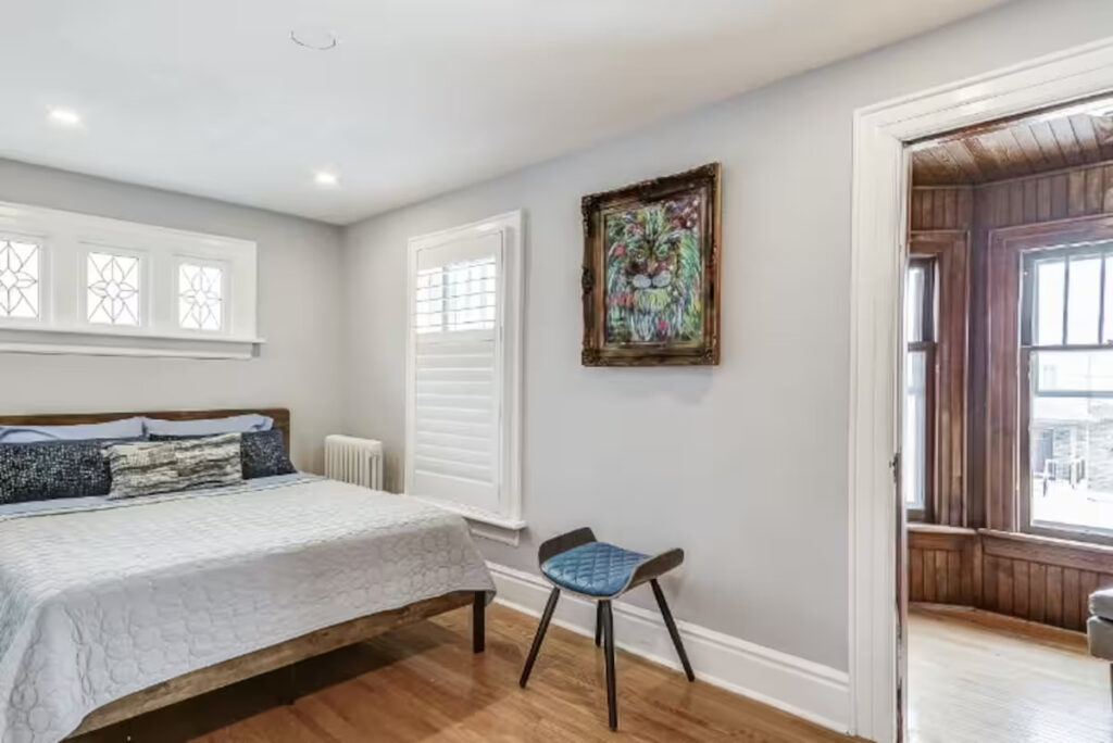 Bedroom with a sitting area in a furnished Niagara Falls monthly rental