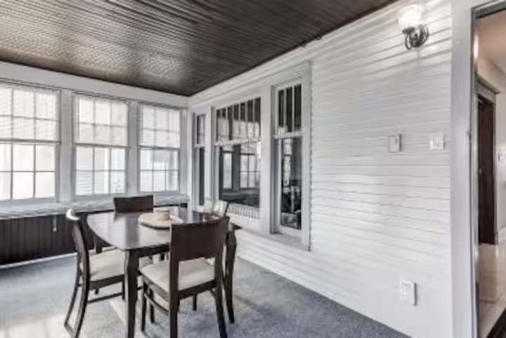 Dining area with white shiplap walls in a furnished Niagara Falls rental