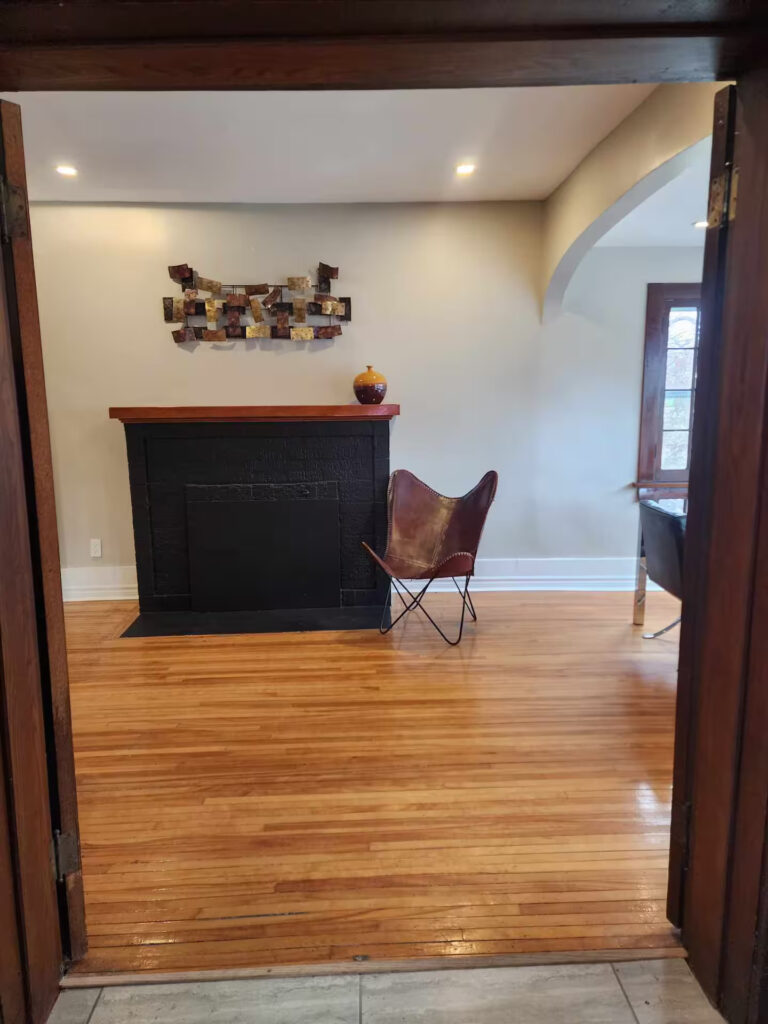 Open dining and bar area with hardwood floors in a furnished Niagara Falls home