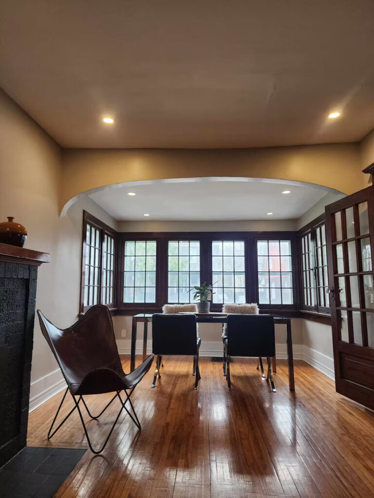 Sitting and dining area with bay windows in a furnished Niagara Falls home
